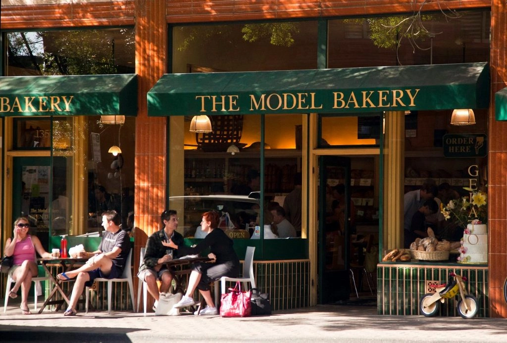 Entrance to The Model Bakery with seating outside. 