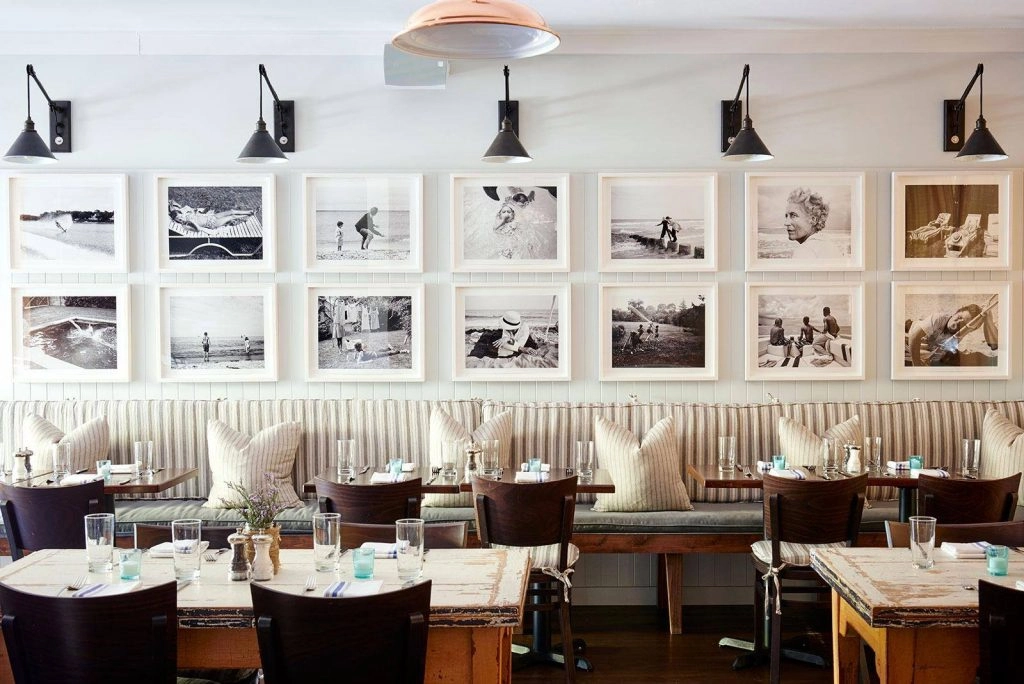 photos on wall above the seating area at the Highway Restaurant Hamptons 