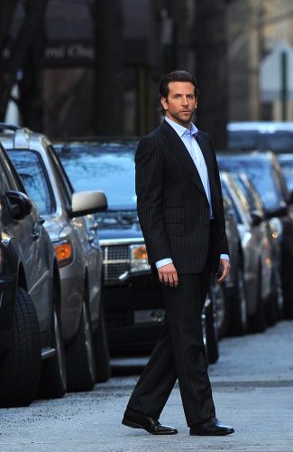 man in a blue suit against a backdrop or cars on a street, where do celebrities stay in Paris