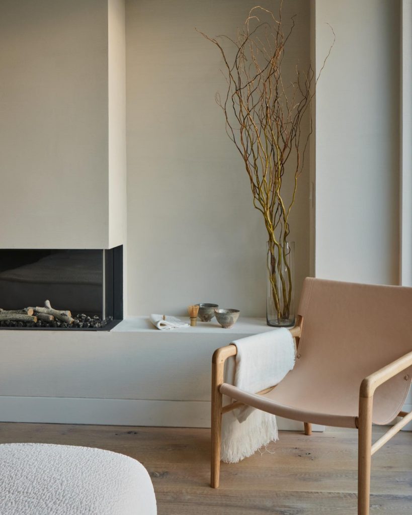 chair beside fireplace in the hamptons