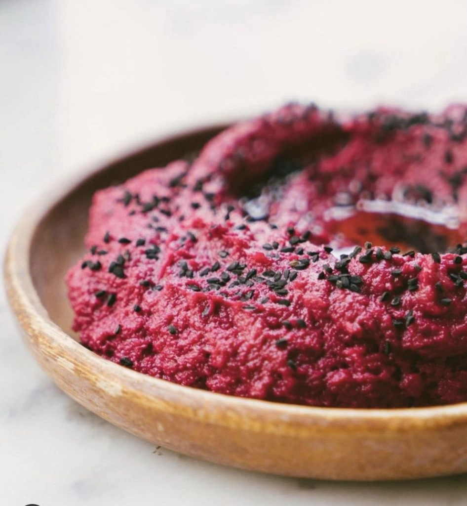 Deep red soft serve ice cream on a terracotta plate at Shukette.