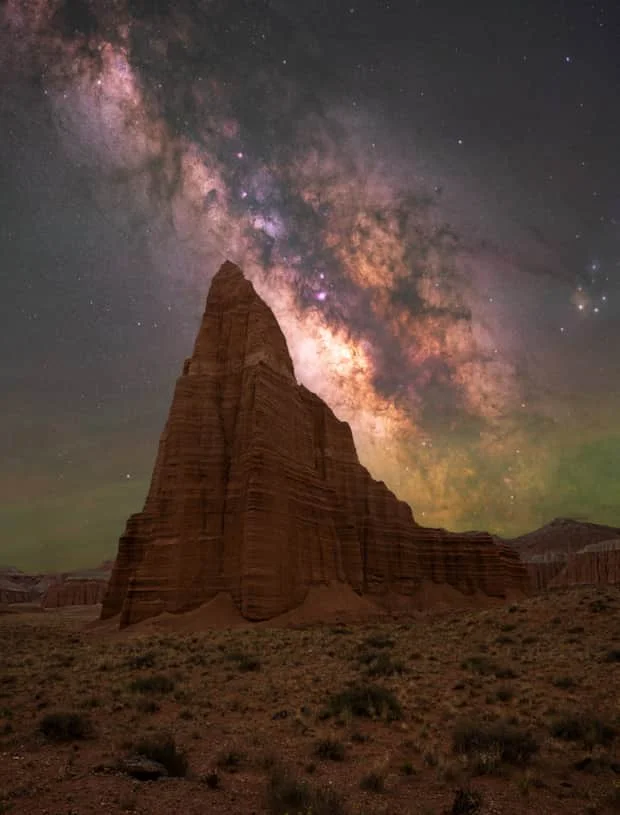 Cathedral Valley rock formations beneath the Milky Way in Utah desert at night